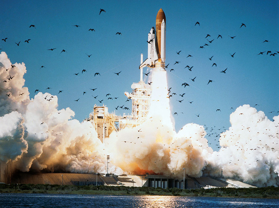 Challenger spacecraft and booster rocket shortly after liftoff