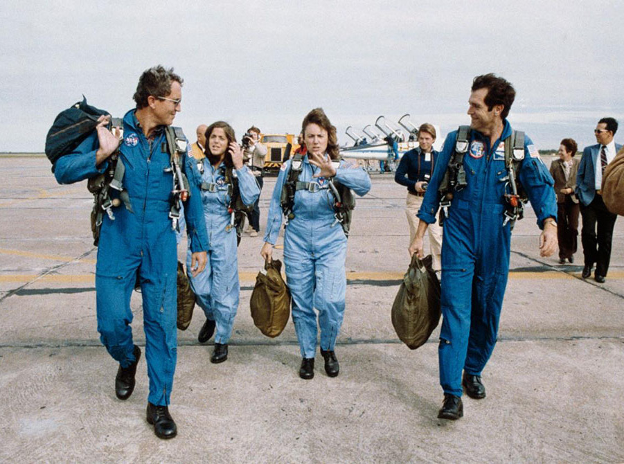 Smith and other astronauts walking on the tarmac after a flight