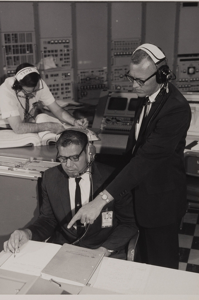 Three NASA scientists, including Arthur Case, work in a control room