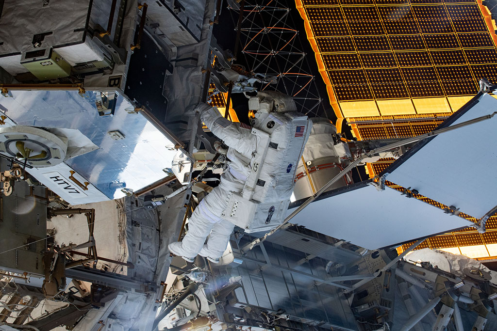 Christina Koch working on the space station during her first spacewalk