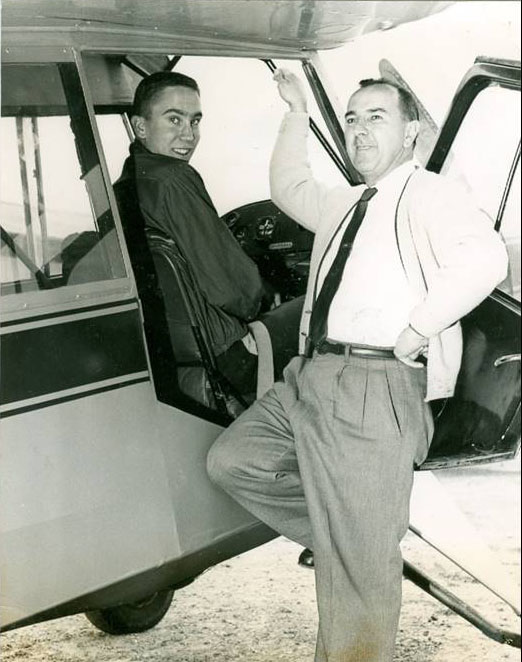Michael Smith sitting on the cockpit of a plane for his first solo flight