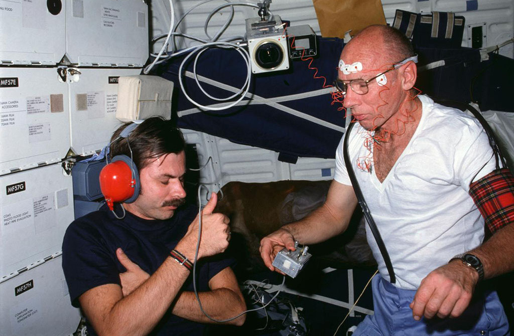Dr. Thornton and another astronaut doing testing in the space station