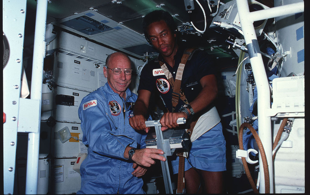 Dr. Thornton and another astronaut using a treadmill