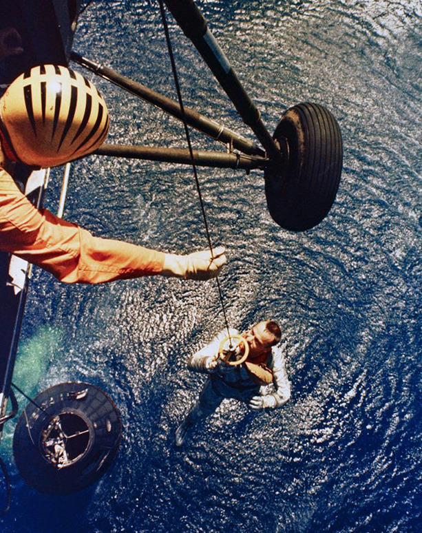 Marine co-pilot George Cox winching up Alan Shepard out of the ocean and into a helicopter