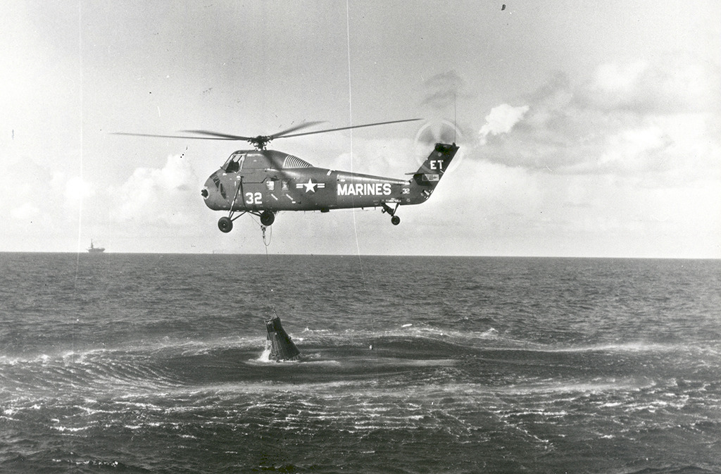 Marine helicopter attempts unsuccessfully to pull the Mercury-Redstone 4 capsule out of the ocean
