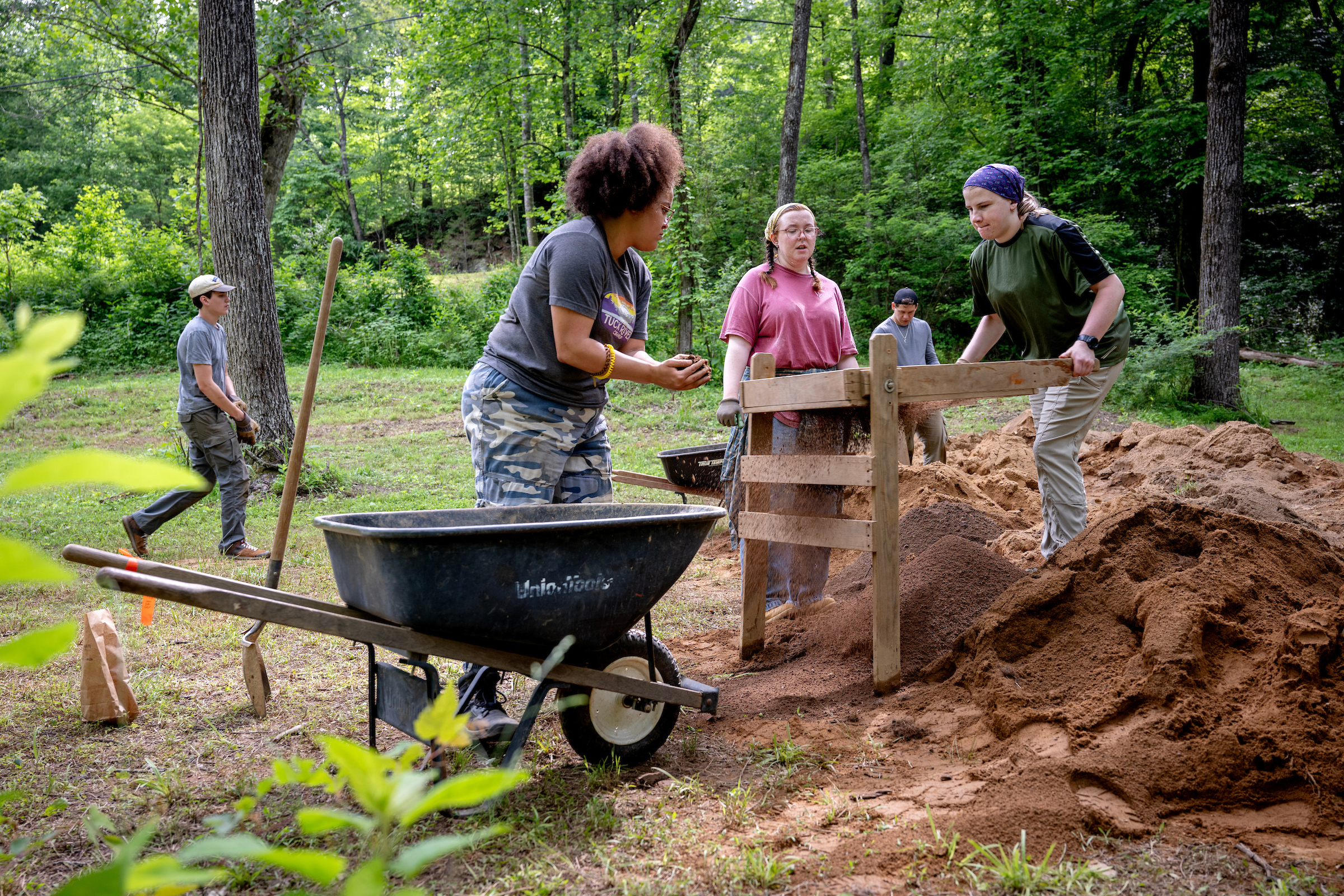 Undergraduate students from Western Carolina University search for artifacts during excavations at the Cowee Tunnel Prison Labor Camp