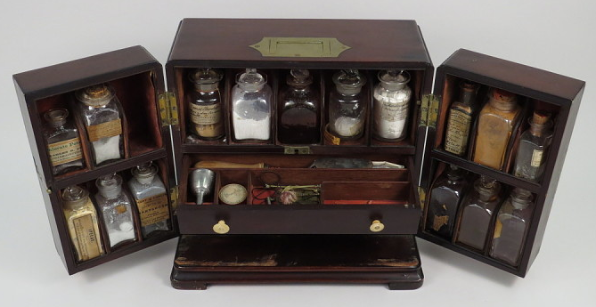 Wooden medicine case folded out to reveal compartments for seventeen different medicinal powders and other medical equipment