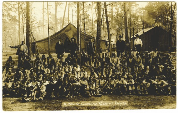 “A North Carolina Convict Camp” in Lauringburg, 1910. Five men in the front row hold dogs trained to track runaways. 