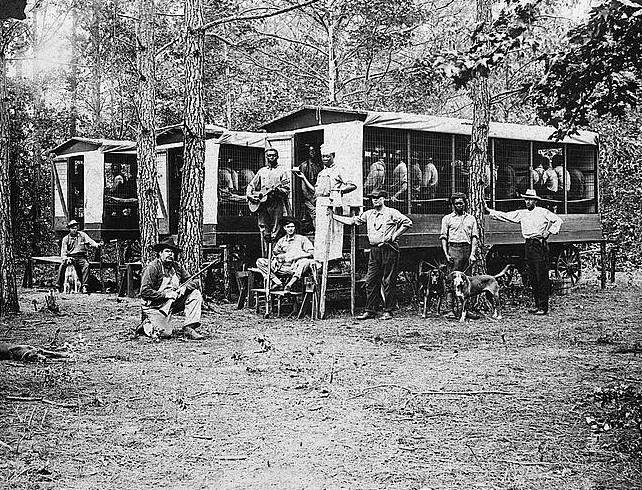 Chain gang of convicts engaged in road work in Pitt County, North Carolina. The inmates were quartered in the wagons.