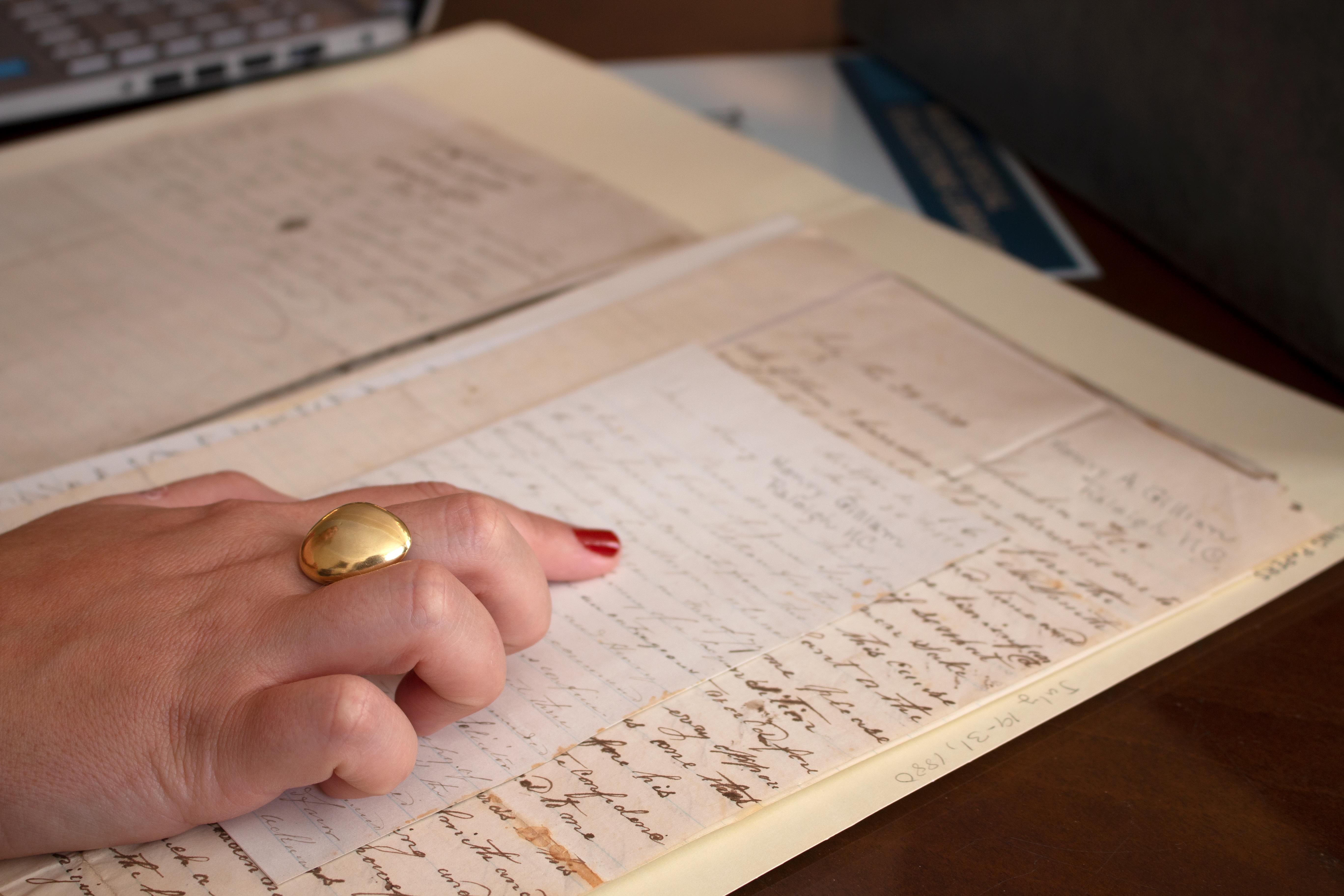 photo of a hand over an archival document